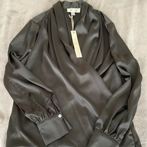 Brand new, never worn gorgeous black top. Zips on the side.